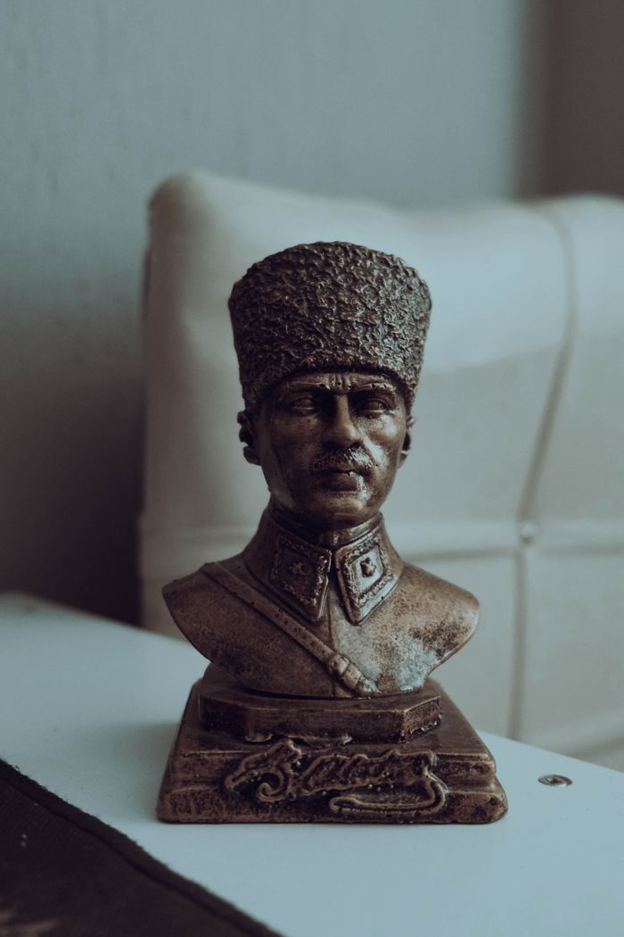 Bronze bust of Atatürk placed indoors with soft lighting creating a classic aesthetic.